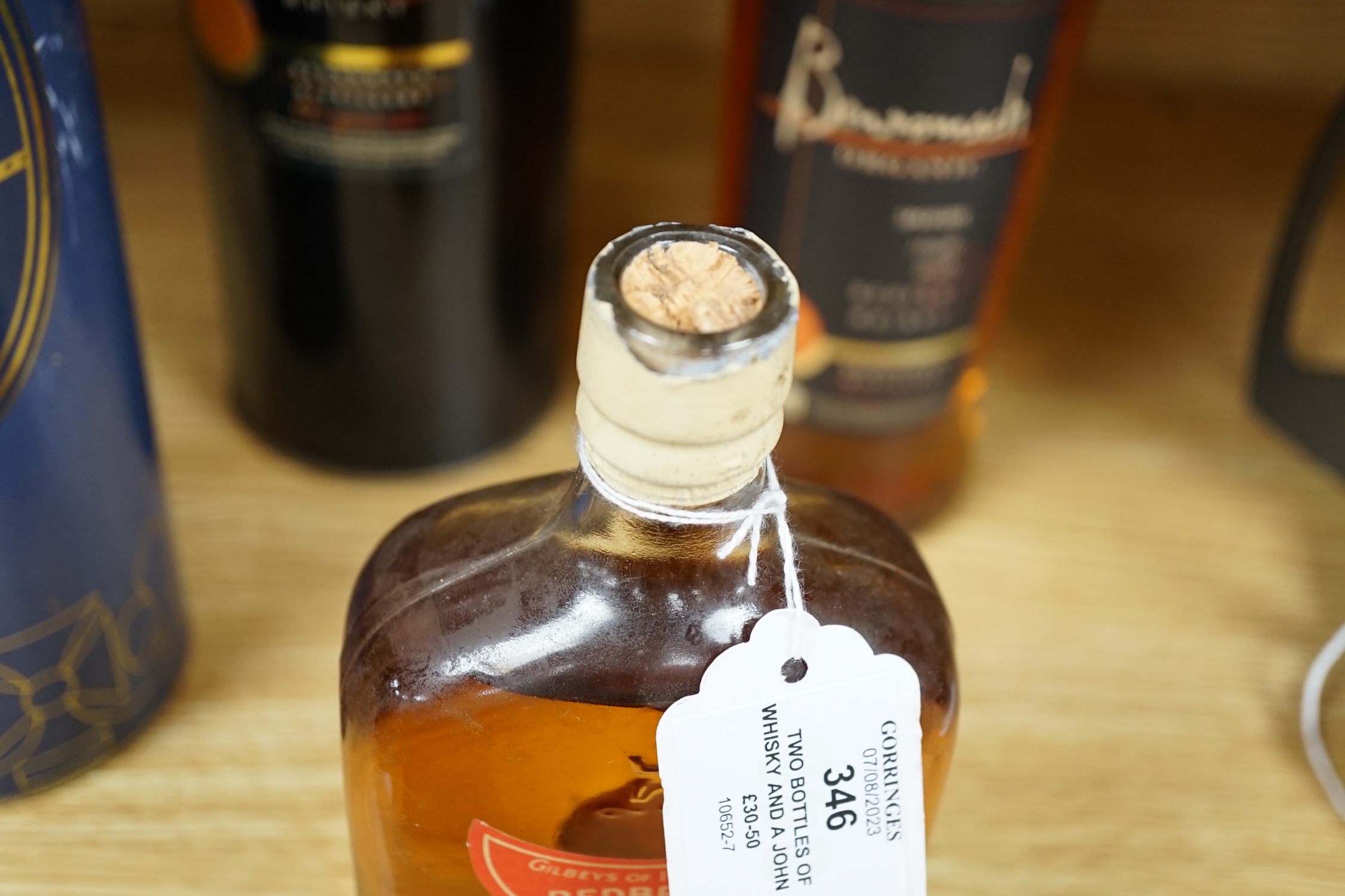 Two bottles of whisky and a John Jameson & Sons bottle